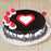 round-black-forest-cake-with-heart-in-center-and cherries-on-top