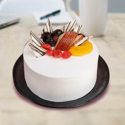 round-shape-white-color-cake-with-fruit-on-top
